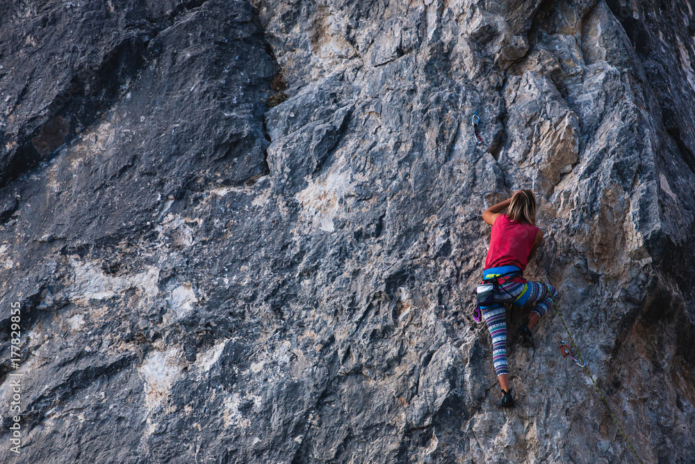 The girl climbs the rock. The girl climbs the rock.