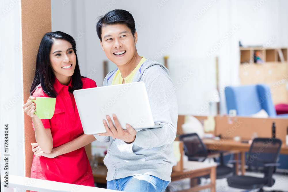 Two determined employees smiling while planning a successful business strategy for the future of the company Two determined employees smiling while planning a successful business strategy for the future of the company