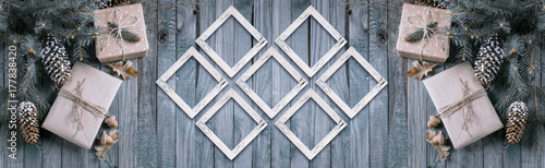 Christmas background with gift box and frames on wooden planks