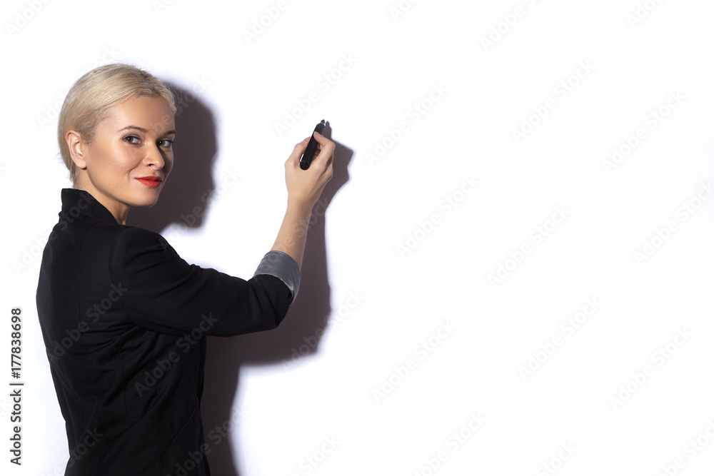 Business Woman Writing notes on a reflective Board. Office fashion Style. Blond model Presentation with Marker on White Business Woman Writing notes on a reflective Board. Office fashion Style. Blond model Presentation with Marker on White