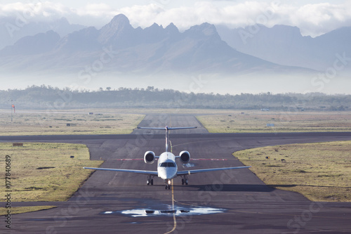 Aircraft taxiing at Cape Town airport with mountains in the background