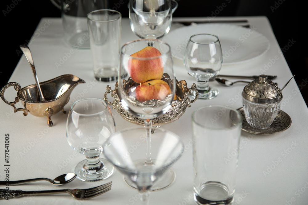apples on a festive table with glasses and cutlery