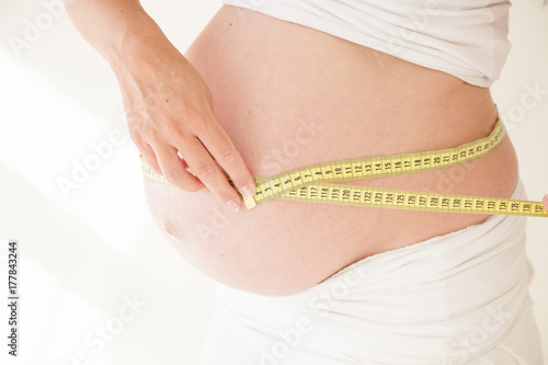 Wallpaper Mural the stomach of a pregnant woman and a measuring tape Torontodigital.ca