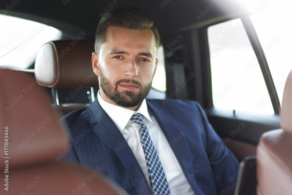 Close-up of a successful businessman sitting in a car