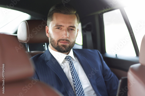 Close-up of a successful businessman sitting in a car © ASDF