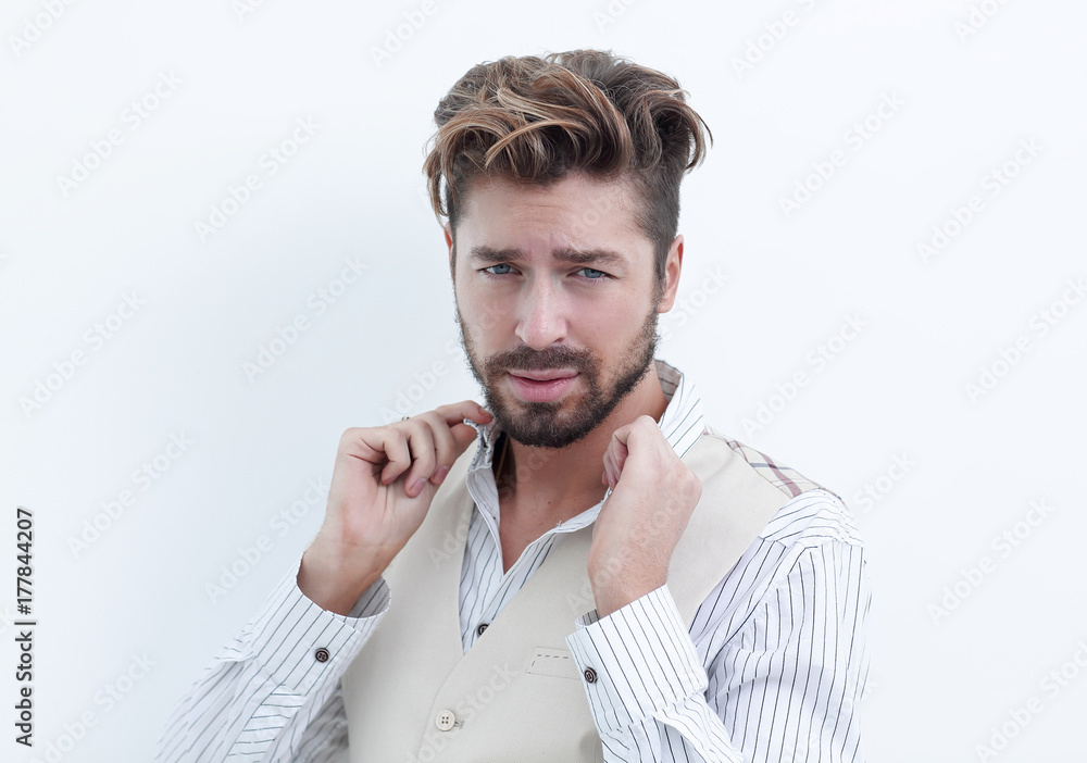 Fototapeta premium A man adjusts the collar of a white shirt