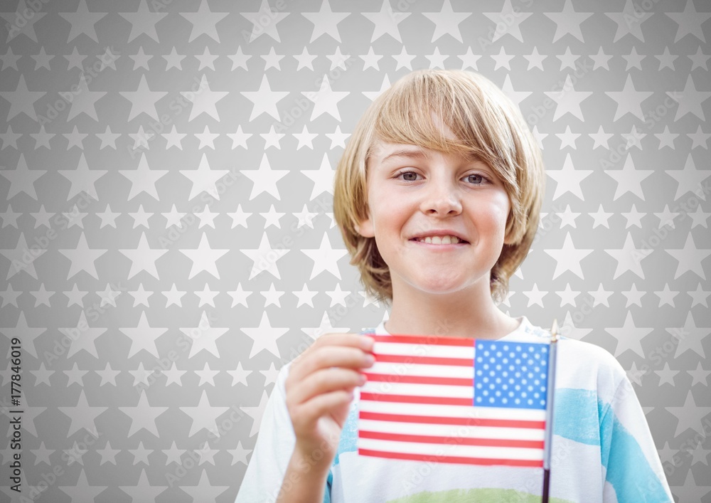 Boy against grey background with american flag and stars Boy against grey background with american flag and stars