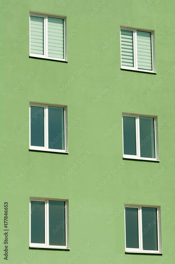six windows on a three-story green house