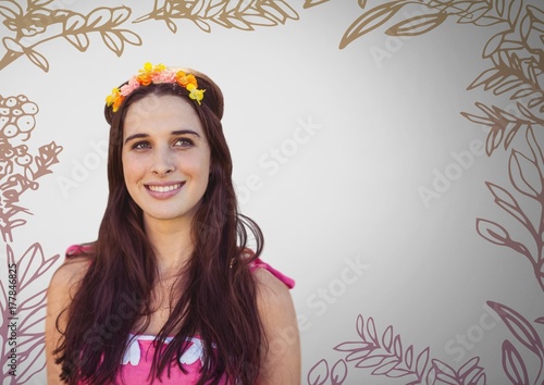 Young woman against grey background with flowers in hair and photo