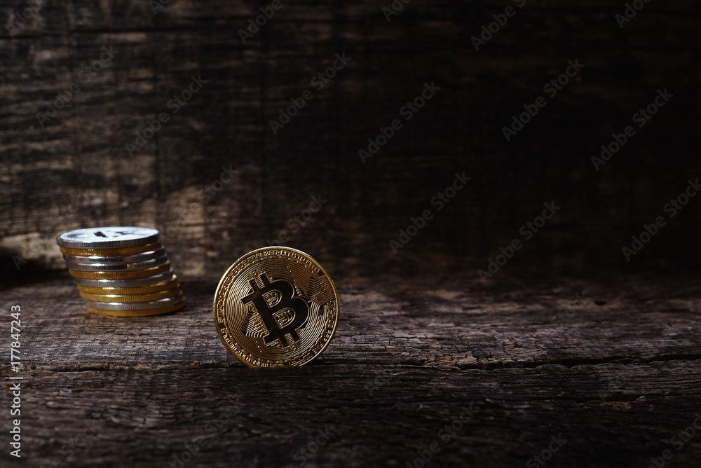 Many golden and silver bitcoins on a wooden surface, background with vintage effect, cryptocurrency concept for business idea, closeup, set Many golden and silver bitcoins on a wooden surface, background with vintage effect, cryptocurrency concept for business idea, closeup, set