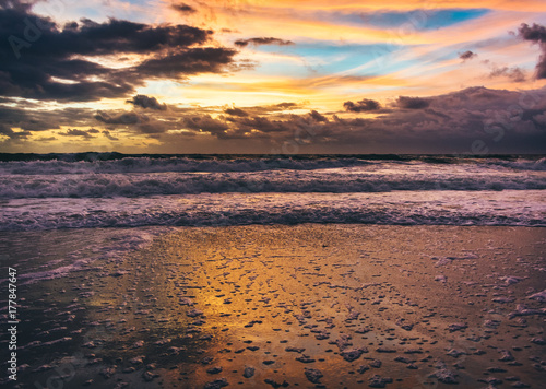 bubbles on wet sand as the tides recede on an early morning at the beach