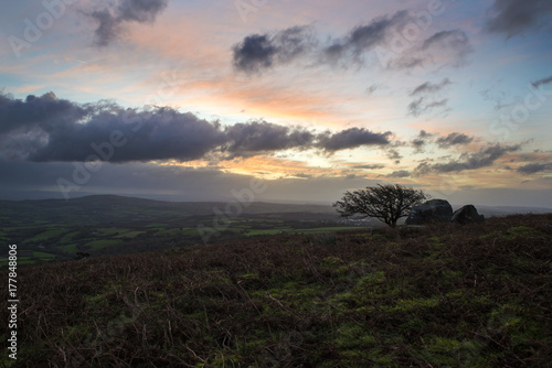 sunrise at caradon hill, cornwall, with cloudy dark sky and muted colours