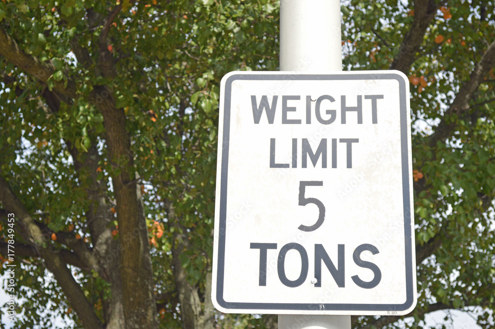 Photo of a rectangular road sign reading weight limit 5 tons Photo of a rectangular road sign reading weight limit 5 tons