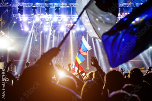 Russian flag at the concert, opposite the light from the stage.