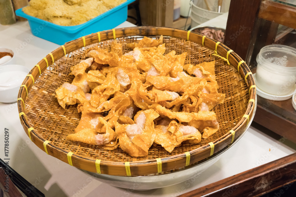 Thai style deep-fried pork dumpling in wicker basket Thai style deep-fried pork dumpling in wicker basket