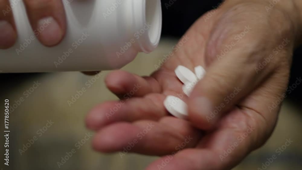 Elderly Man Throws Pills Into His Hand From A Plastic Container Elderly Man Throws Pills Into His Hand From A Plastic Container