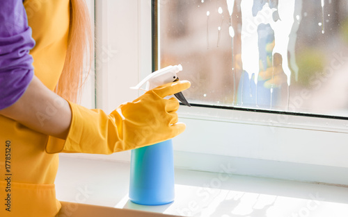 Woman hand cleaning window