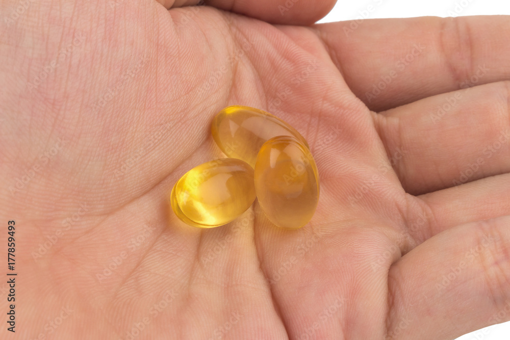 hold fish oil eating.Capsules fish oil isolate on white background hold fish oil eating.Capsules fish oil isolate on white background
