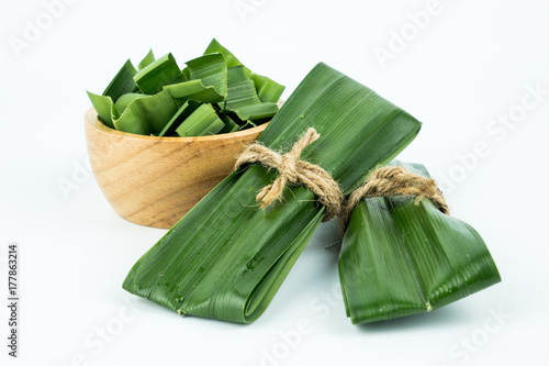 pandan and Chopped pandan in a wooden cup isolated on a white background. photo