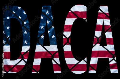 DACA bold letters with american flag and chain link fence in the background