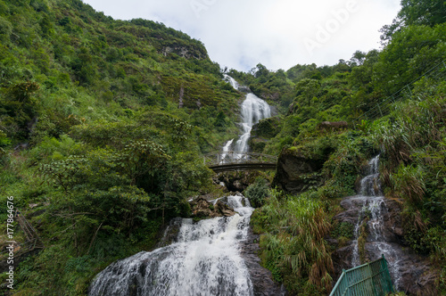 Silver waterfall with arch bridge