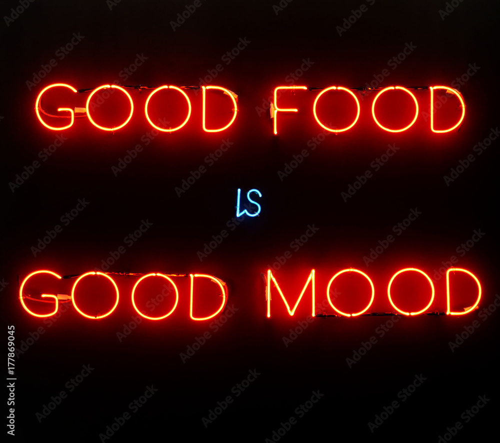 Obraz premium Illuminated neon sign showing good food is good mood on black background