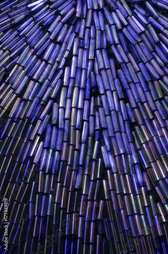 patterns and colors of blue beads on an antique purse, closeup macro