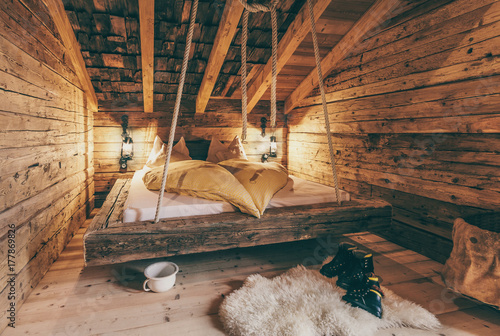 rustic sleepingroom in an old wooden alpine cabin photo