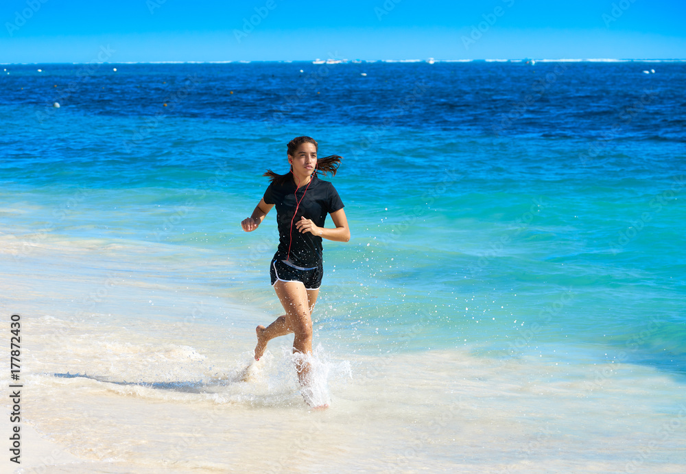 Latin girl running in caribbean shore beach