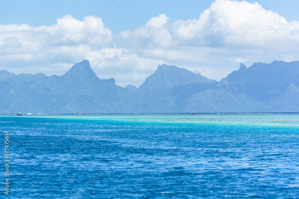 Tahiti in Polynesia, beautiful panorama of the mountains and the barrier reef from the sea 
