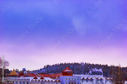 The city's skyline. The roofs of the houses in twilight at sunset in cloudy weather