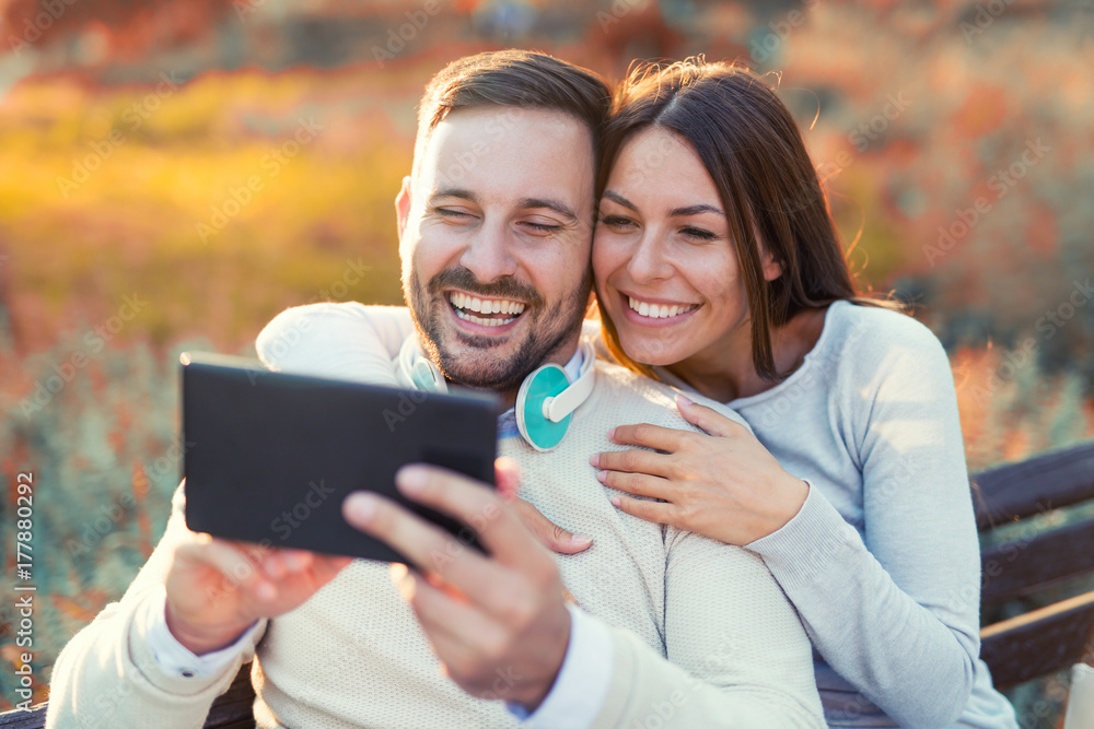 Young attractive couple talking and looking at digital tablet. Young attractive couple talking and looking at digital tablet.