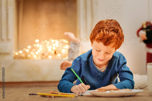 Charming little boy writing letter to father christmas photo