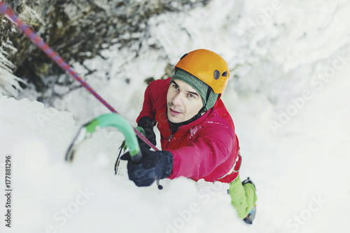 Ice climbing in the mountains along the waterfall.