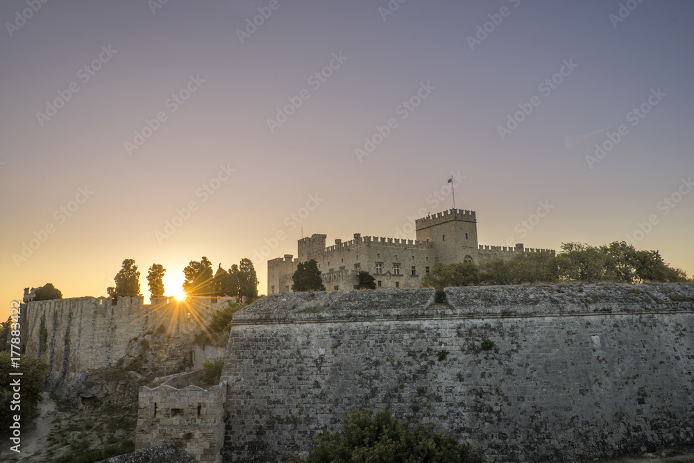 The fortress wall in the harbor at sunset. Rhodes