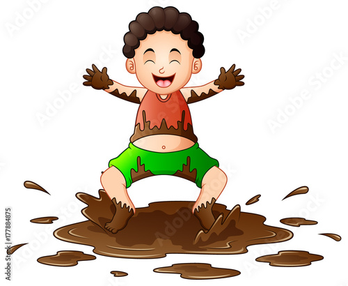 Little boy playing in the mud