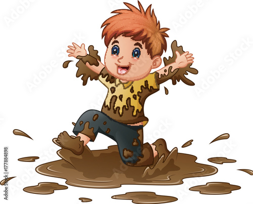 Little boy playing in the mud