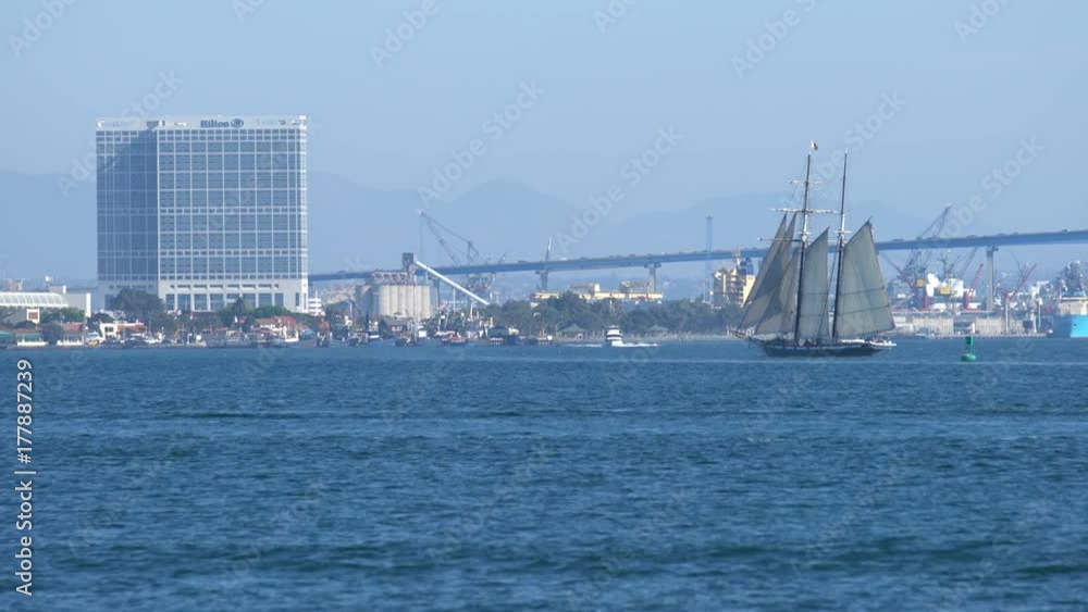 San Diego Skyline and Sailing Ship America Cruising On Ocean San Diego Skyline and Sailing Ship America Cruising On Ocean