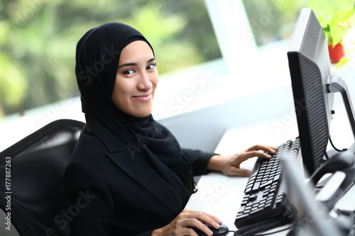Beautiful muslim business woman smiling at camera