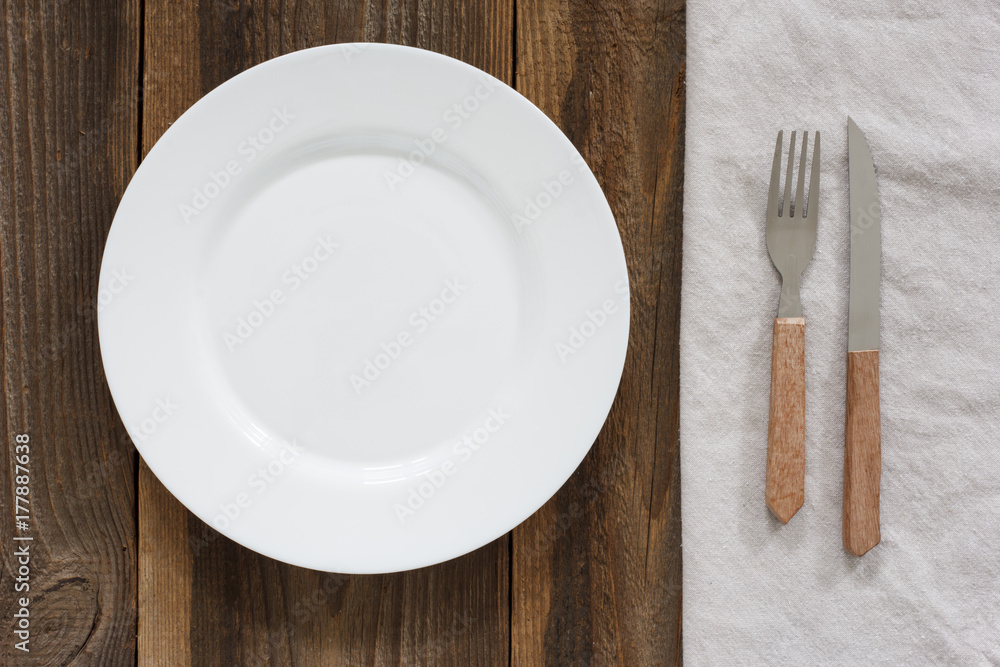Empty Plate And Cutlery On The Wooden Table Empty Plate And Cutlery On The Wooden Table