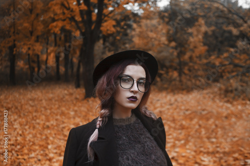 A portrait of girl is spectacled on a background the forest