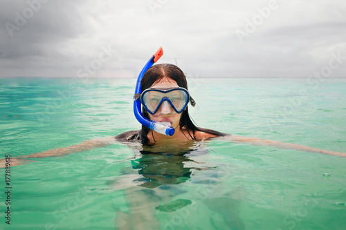 Portrait of young woman wearing mask for snorkeling in ocean