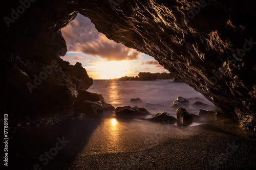 Lava tunnel at sea at sunset, maui island cave, hawaii, usa photo