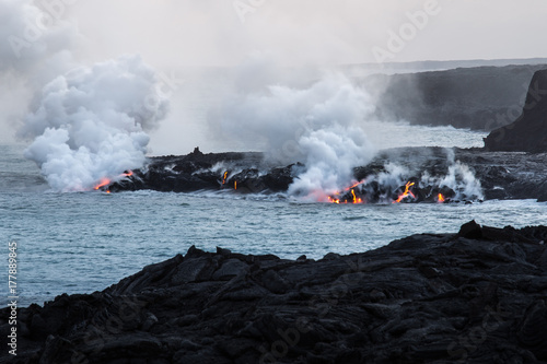 Molten lava flowing into the sea to Pacific Ocean on Big Island of Hawaii, USA