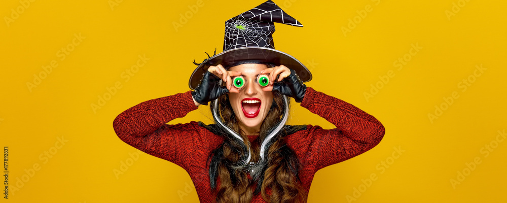 Fototapeta premium happy modern woman on yellow background having fun time