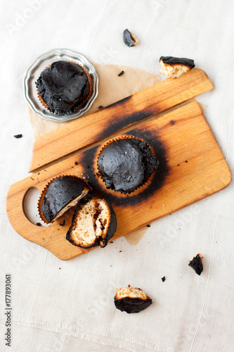 Obraz na płótnie burned muffins - black cupcakes, failed baking, catastrophe in the kitchen, burned on charcoal w salonie