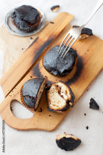 Obraz na płótnie burned muffins - black cupcakes, failed baking, catastrophe in the kitchen, burned on charcoal w salonie