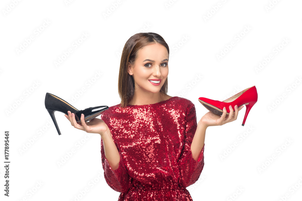 woman holding high heeled shoes woman holding high heeled shoes