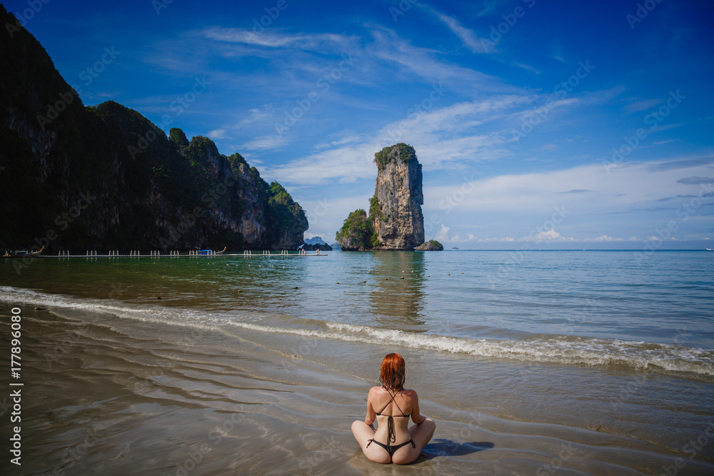 Young fashion woman relax on the beach. Happy island lifestyle. White sand, blue cloudy sky and crystal sea of tropical beach. Vacation at Paradise. Ocean beach relax, travel to Thailand, Krabi