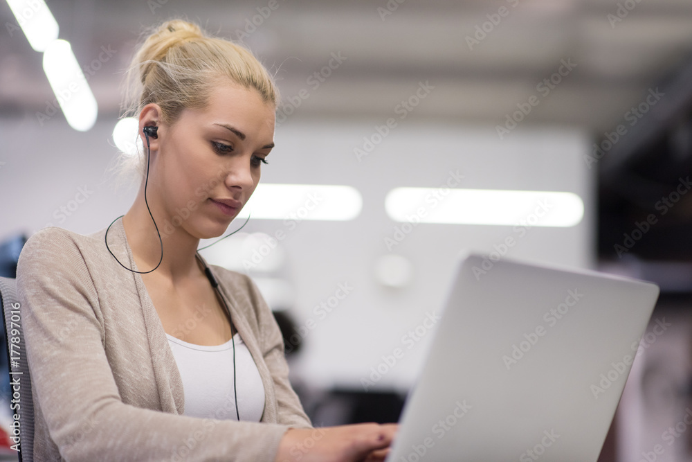 businesswoman using a laptop in startup office businesswoman using a laptop in startup office